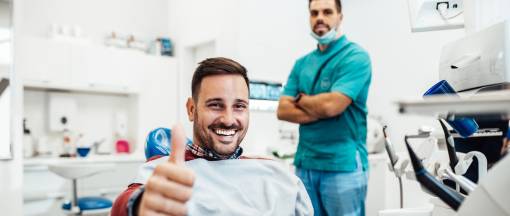 Man smiling in a dental clinic.