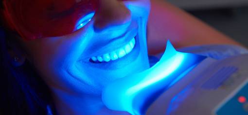 Woman in teeth whitening procedure⁠